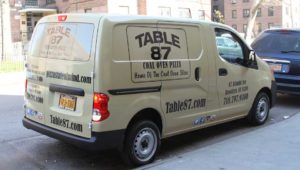 Van vinyl decals advertising in Brooklyn by KNAM